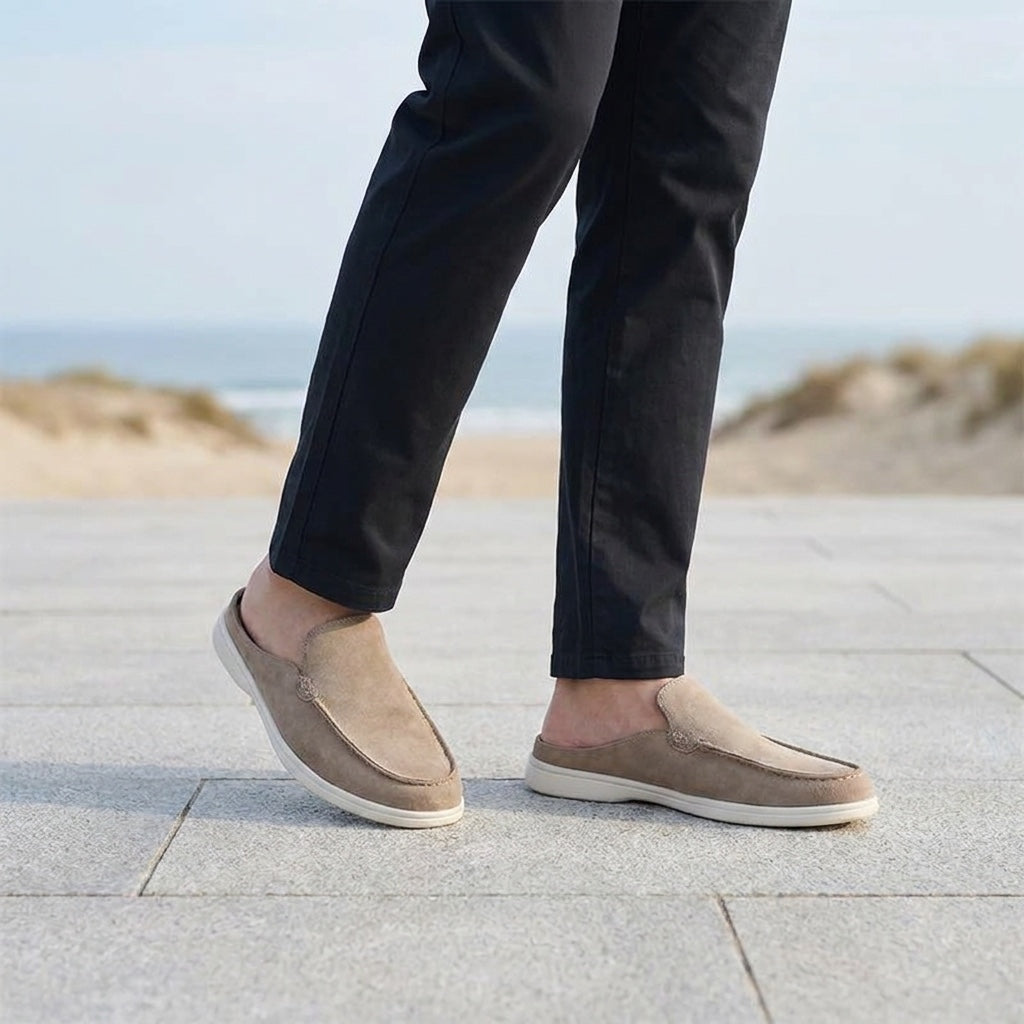 Dartmouth Suede Loafers — Beige, male model knee-down coastal pavement