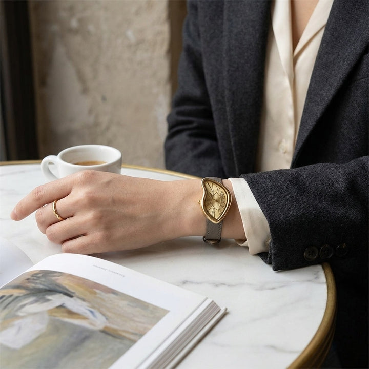 Basel Twisted Watch — Grey, worn at a cafe table