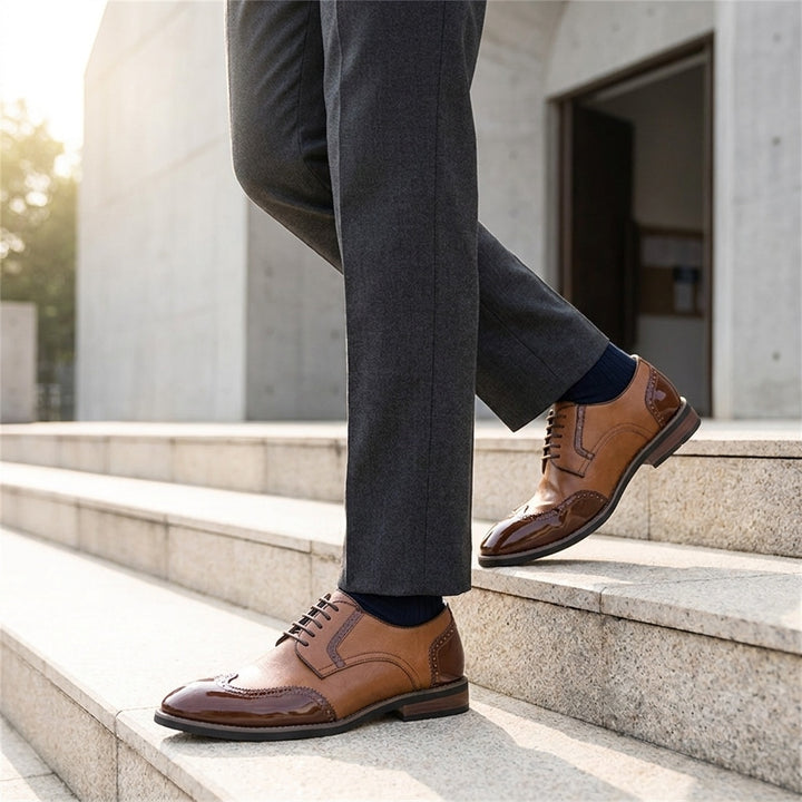 Tortona Leather Wingtip Brogues — Cognac, worn on stone steps