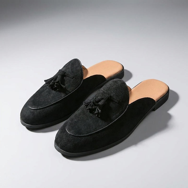 Vasto Suede Mules — Black, three-quarter front view, both shoes paired, open-back visible