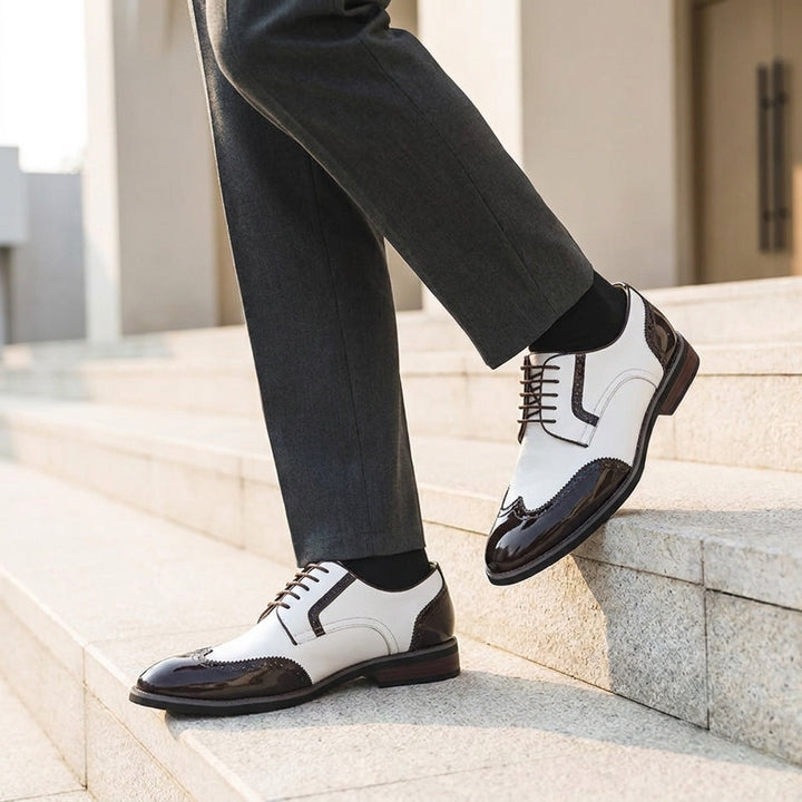 Tortona Leather Wingtip Brogues — White, worn on stone steps