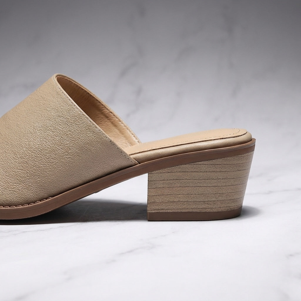 Lucera Leather Mules — Sand, close-up of the block heel and stitched sole edge