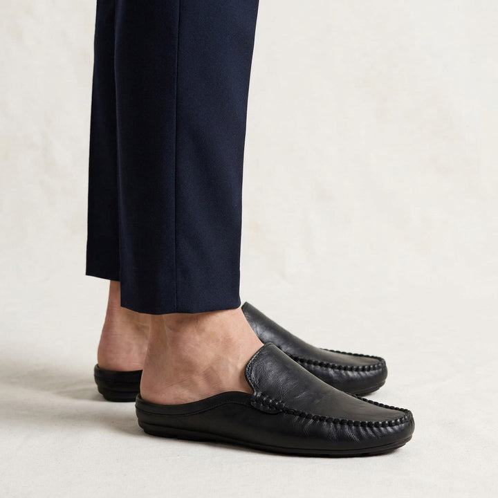 Vietri Leather Mules — Black, studio model knees down