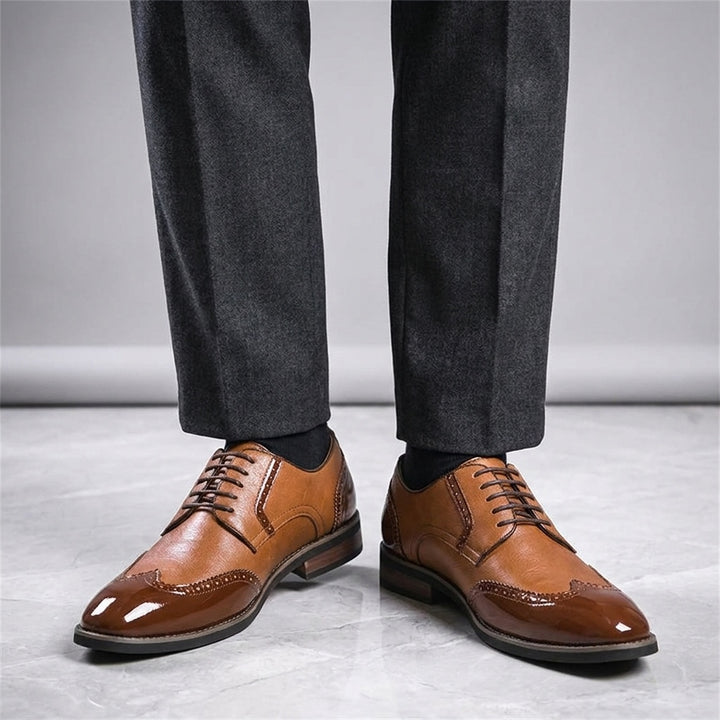 Tortona Leather Wingtip Brogues — Cognac, worn with suit trousers on a marble floor