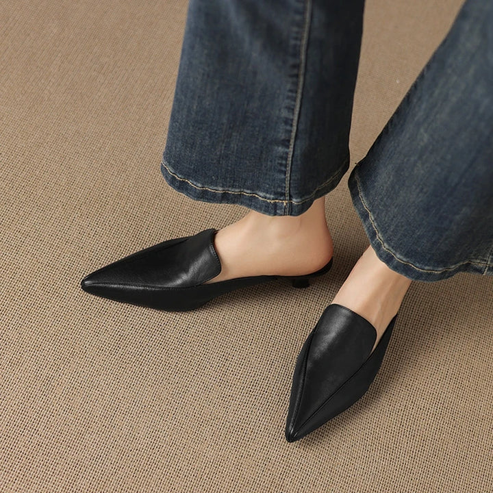 Camaiore Pointed-Toe Mules — Black, worn with blue jeans, side-on view