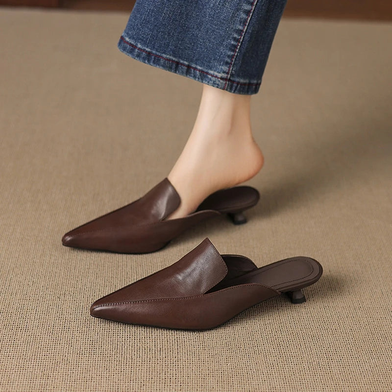Camaiore Pointed-Toe Mules — Brown, worn with blue jeans, pair on carpet