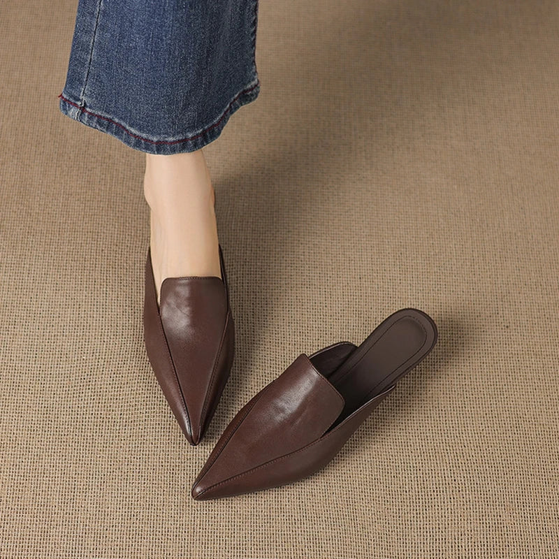 Camaiore Pointed-Toe Mules — Brown, worn with blue jeans, front three-quarter view