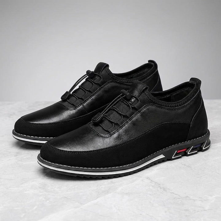 Anagni No-Tie Dress Shoes — Black, pair in three-quarter view on light-grey marble