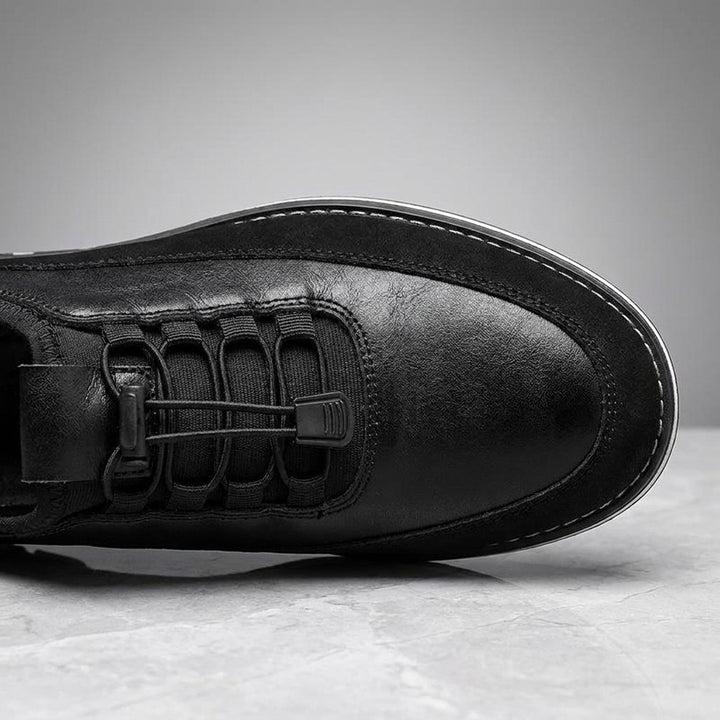 Anagni No-Tie Dress Shoes — Black, close-up of the elastic no-tie laces and stitched upper on light-grey marble