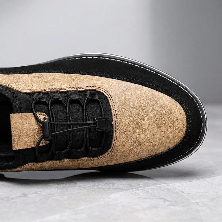 Anagni No-Tie Dress Shoes — Sand, close-up of the elastic no-tie laces and stitched upper on light-grey marble