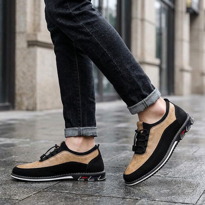 Anagni No-Tie Dress Shoes — Sand, worn with dark cuffed jeans on a city sidewalk outside an office building