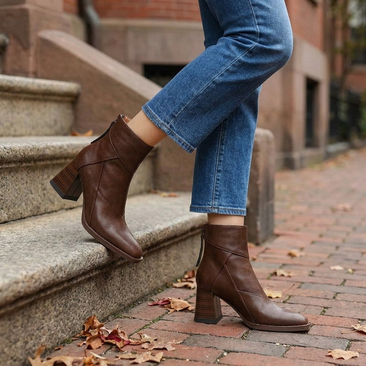 Bormio Paneled Ankle Boots — Brown, worn with cropped blue jeans on a brick sidewalk by brownstone steps