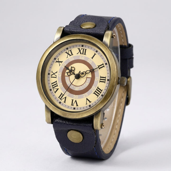 Camerino Heritage Watch — Bronze / Navy, cream Roman-numeral dial on a light-grey studio backdrop