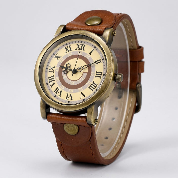 Camerino Heritage Watch — Bronze / Tan, cream Roman-numeral dial on a light-grey studio backdrop
