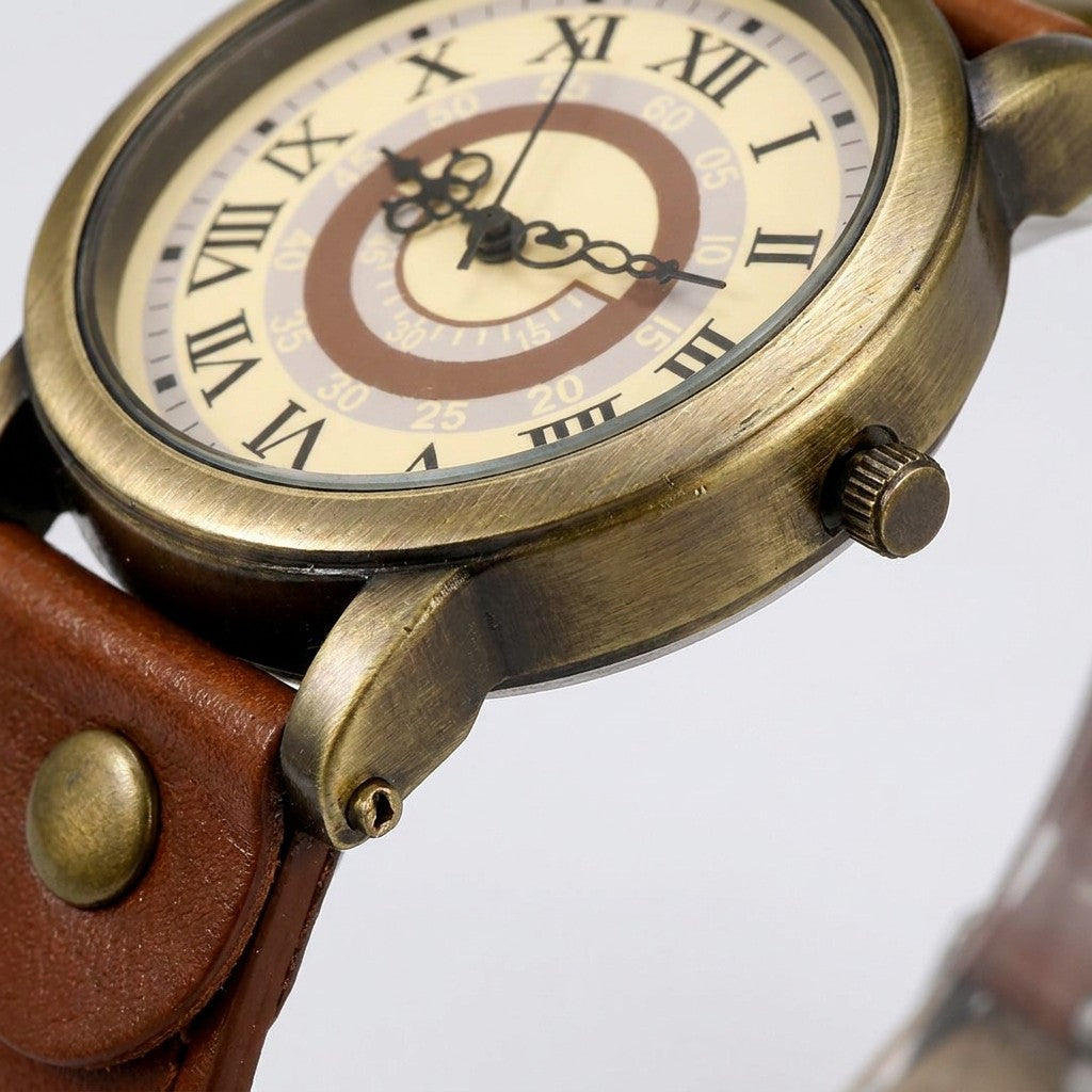 Camerino Heritage Watch — Bronze / Tan, close-up of the bronze-tone case, crown, lug and strap rivet