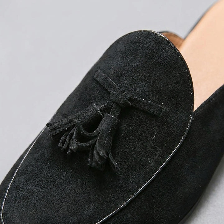 Vasto Suede Mules — Black, close-up tassel and vamp suede texture
