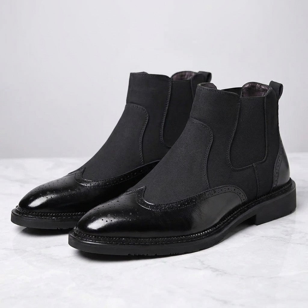 Cittadella Brogue Chelsea Boots — Black, pair of Chelsea boots, three-quarter view on light grey marble