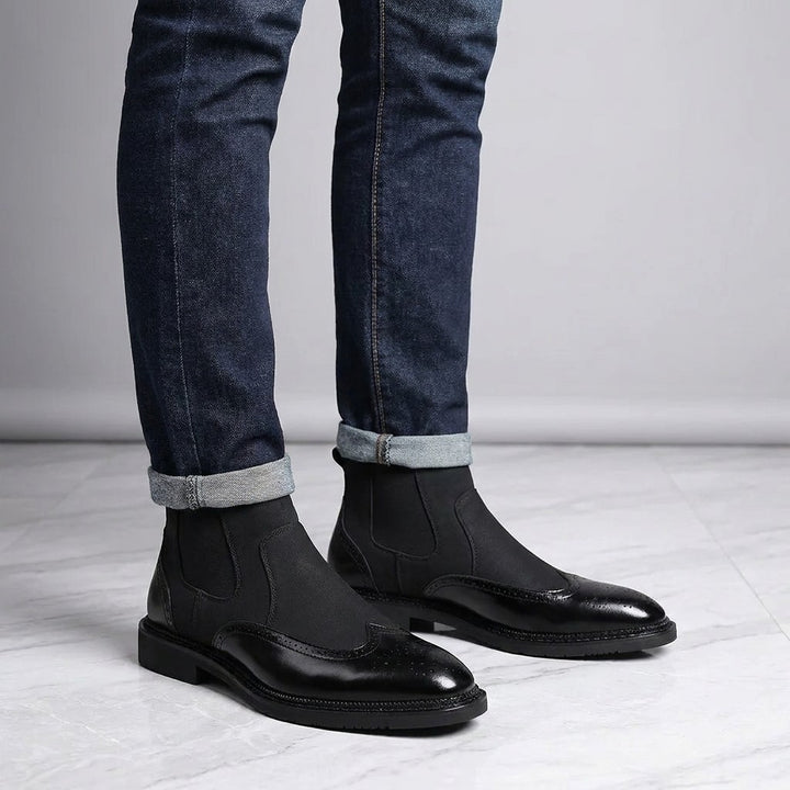 Cittadella Brogue Chelsea Boots — Black, worn with cuffed dark jeans, knee-down on light grey marble