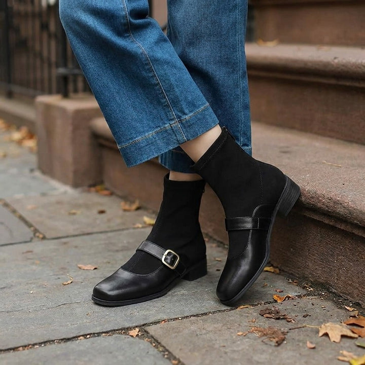 Cosenza Square Toe Ankle Boots — Black, worn by a woman, knee down, on a Brooklyn brownstone sidewalk