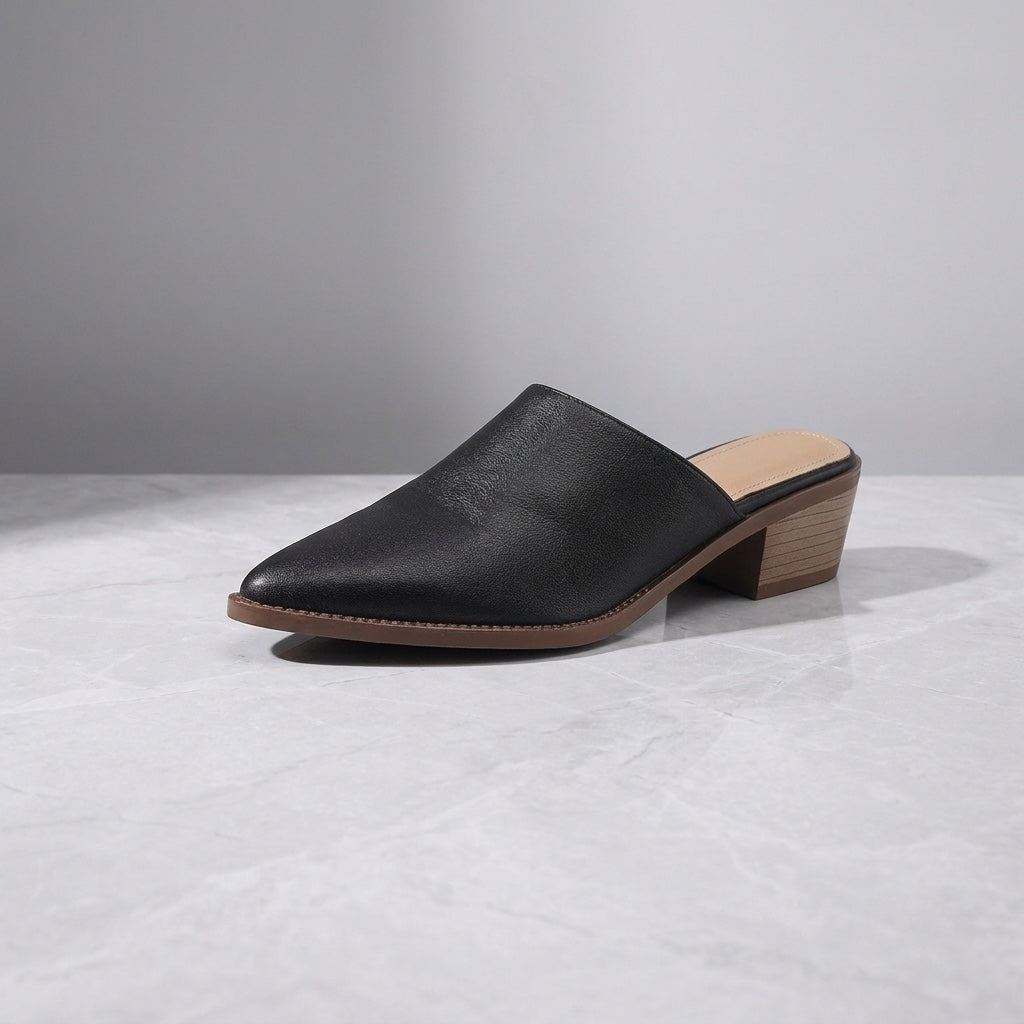 Lucera Leather Mules — Black, three-quarter studio view