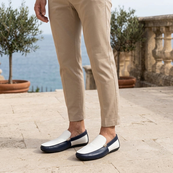 Faro Two-Tone Loafers — Navy &amp; White, worn on a coastal stone terrace