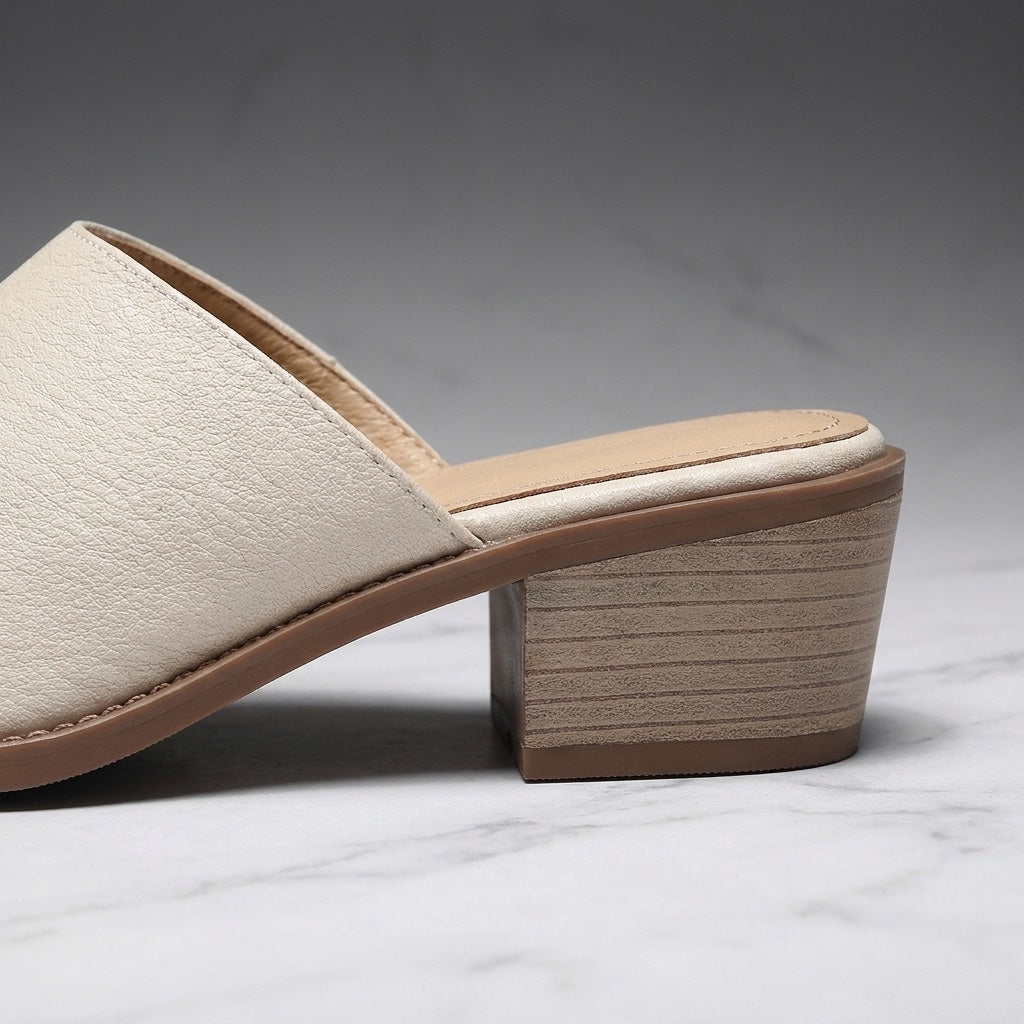 Lucera Leather Mules — Cream, close-up of the block heel and stitched sole edge
