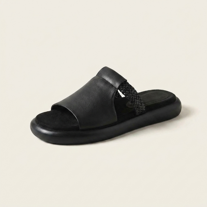 Palermo Leather Slides — Black, three-quarter studio view