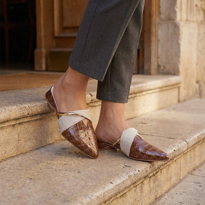 Tivoli Croc-Embossed Mules — Khaki, on model at restaurant steps