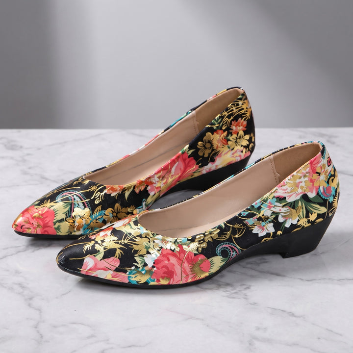 Maiori Pointed-Toe Pumps — Black Floral, pair in three-quarter view on light-grey marble