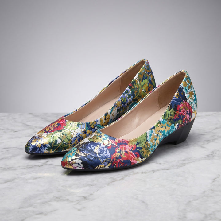 Maiori Pointed-Toe Pumps — Teal Floral, pair in three-quarter view on light-grey marble