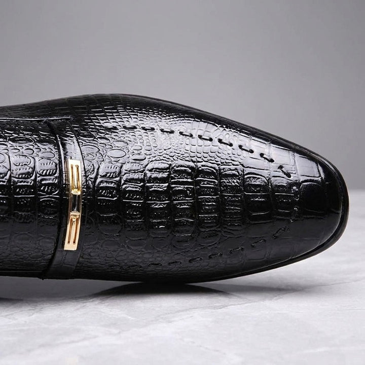 Snakeskin Loafers — Black, close-up of strap ornament and embossed texture