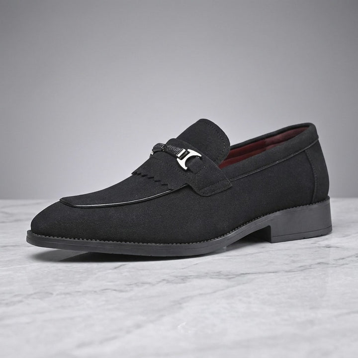 Modica Kiltie Bit Loafers — Black suede, single loafer in side profile on light grey marble