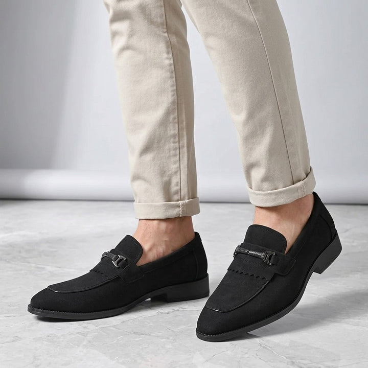Modica Kiltie Bit Loafers — Black suede, worn with cuffed stone chinos, knee-down on light grey marble
