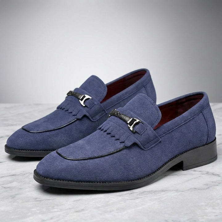 Modica Kiltie Bit Loafers — Blue suede, pair of kiltie bit loafers, three-quarter view on light grey marble