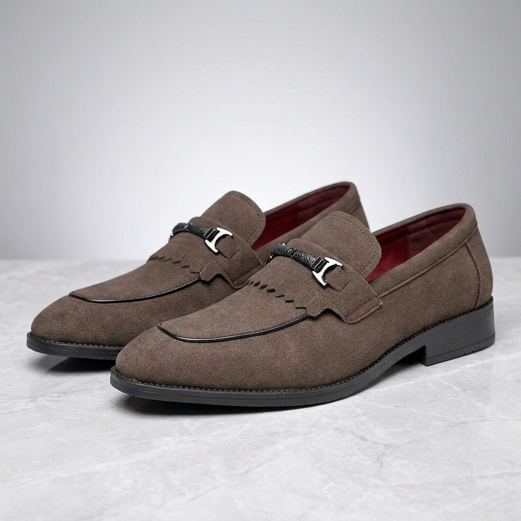 Modica Kiltie Bit Loafers — Brown suede, pair of kiltie bit loafers, three-quarter view on light grey marble