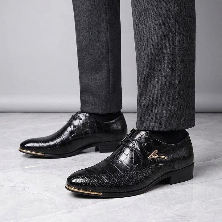 Osimo Croc Dress Shoes — Black, worn by a man, knee-down studio