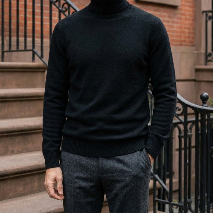 Pistoia Merino Wool Turtleneck — Black, worn on a brownstone stoop