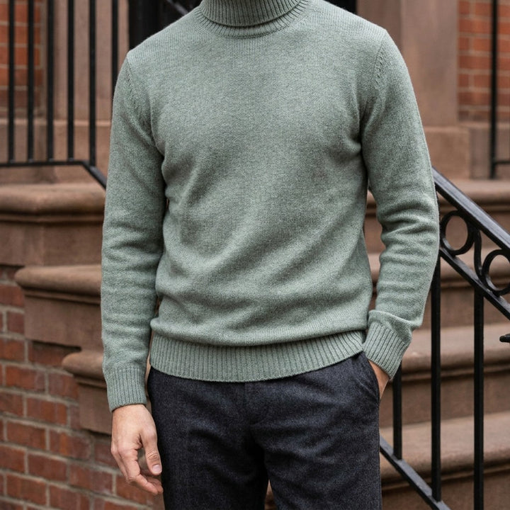 Pistoia Merino Wool Turtleneck — Sage, worn on a brownstone stoop