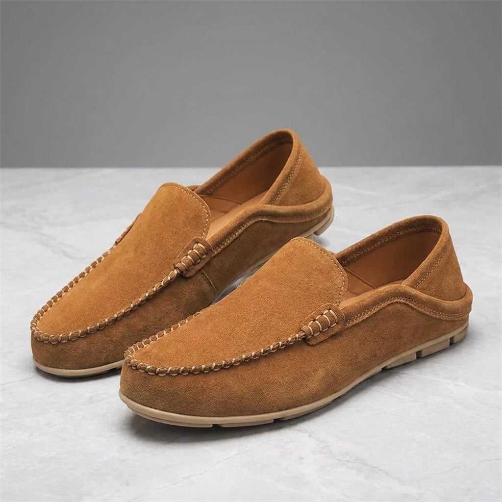 Varazze Suede Loafers — Apricot, pair of loafers, three-quarter view on light grey marble