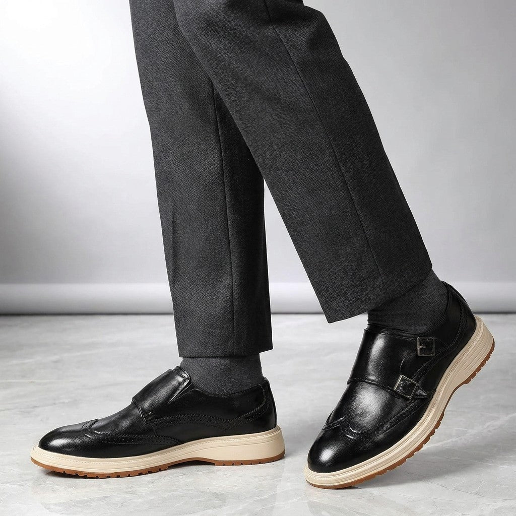Vignola Wingtip Monk Shoes — Black, worn by a man, knee-down studio