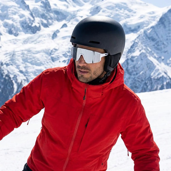 Tellaro Shield Sunglasses — White / Silver Mirror, worn by a man in a helmet skiing in bright sun near Chamonix