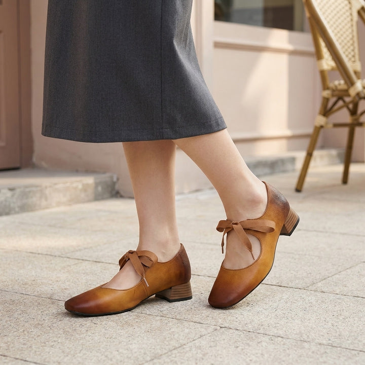 Nemi Square Mary Janes — Yellow Brown, on model urban cafe sidewalk